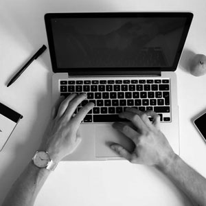 black and white laptop with hands